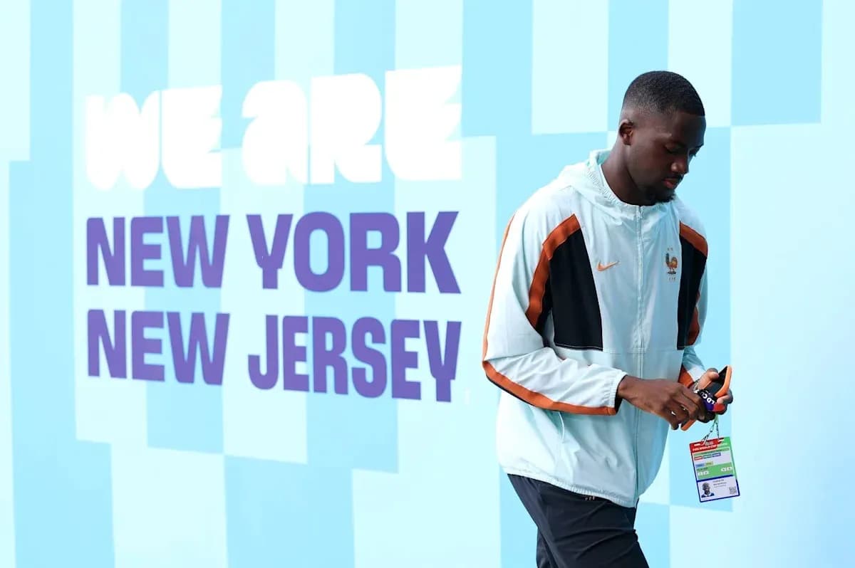 Athlete walking past 'We Are New York New Jersey' sign Athlete walking past 'We Are New York New Jersey' sign
