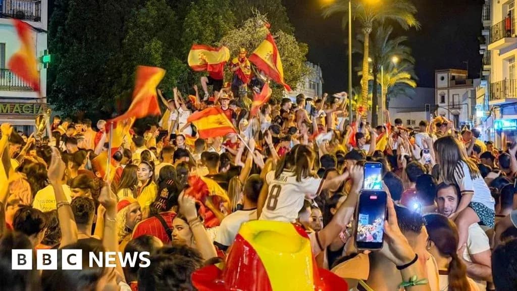 Crowd celebrating with flags in street at night Crowd celebrating with flags in street at night