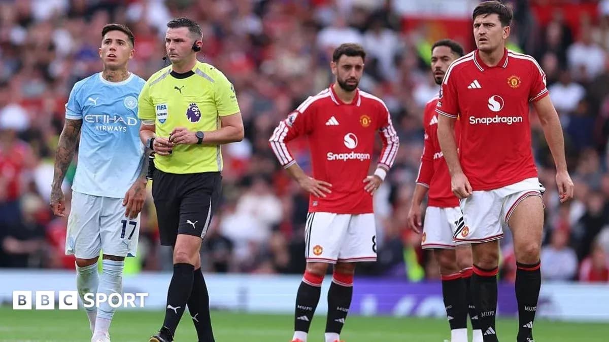 Players and referee during Manchester derby match Players and referee during Manchester derby match