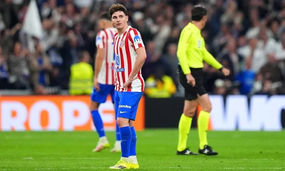 Atletico Madrid player looking disappointed on pitch Atletico Madrid player looking disappointed on pitch