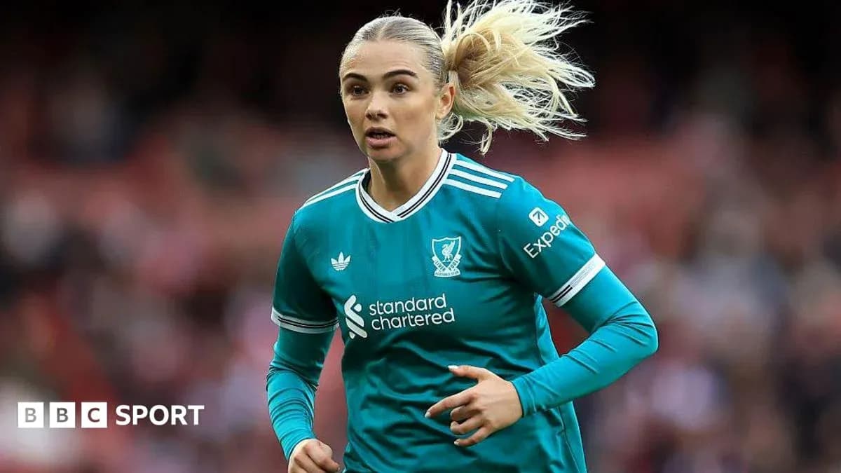 Player in Liverpool kit running on the pitch Player in Liverpool kit running on the pitch