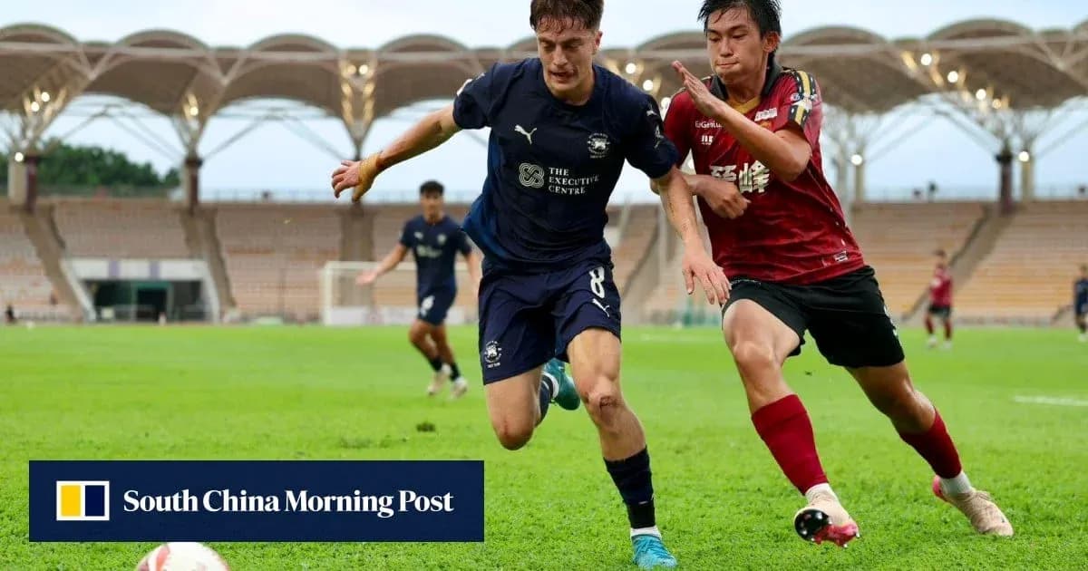 Player in blue jersey chasing ball, red player defending Player in blue jersey chasing ball, red player defending