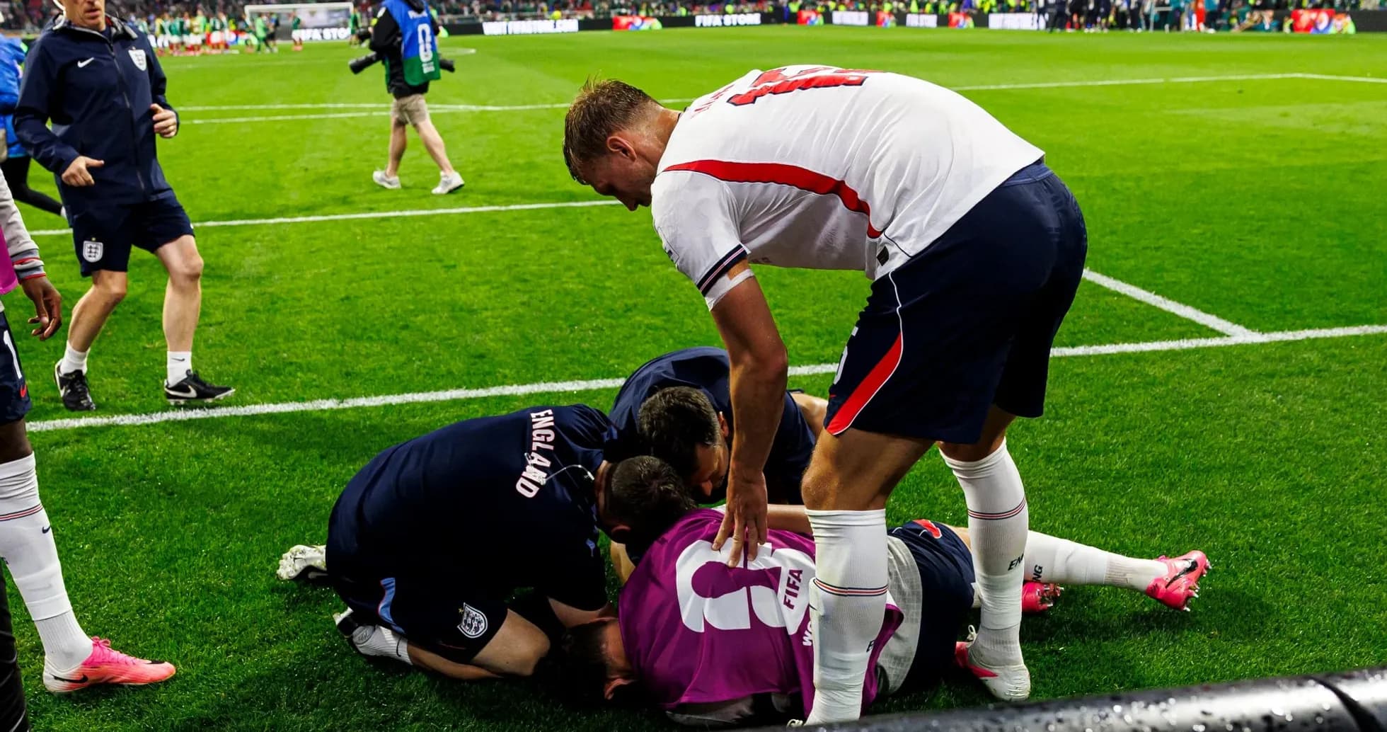 Players and staff attending to an injured teammate Players and staff attending to an injured teammate