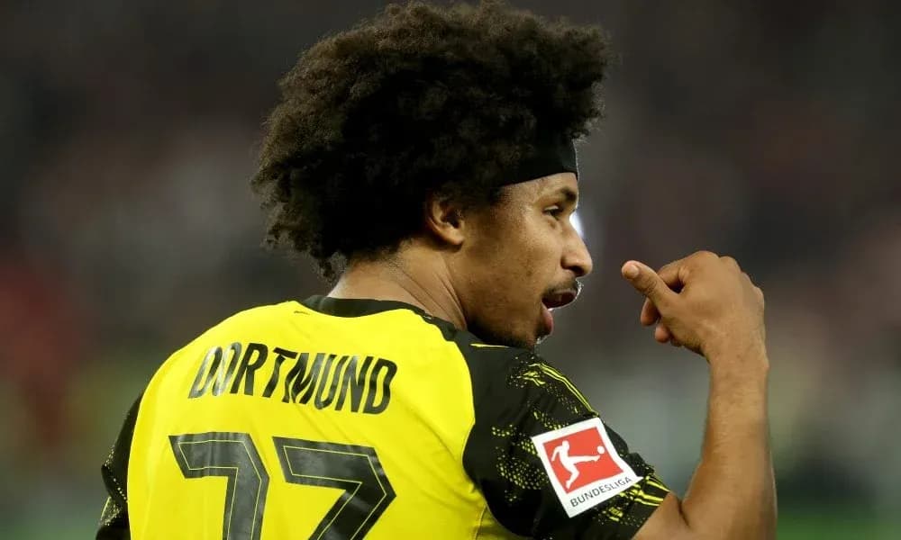 Player wearing Dortmund jersey celebrating on the field Player wearing Dortmund jersey celebrating on the field