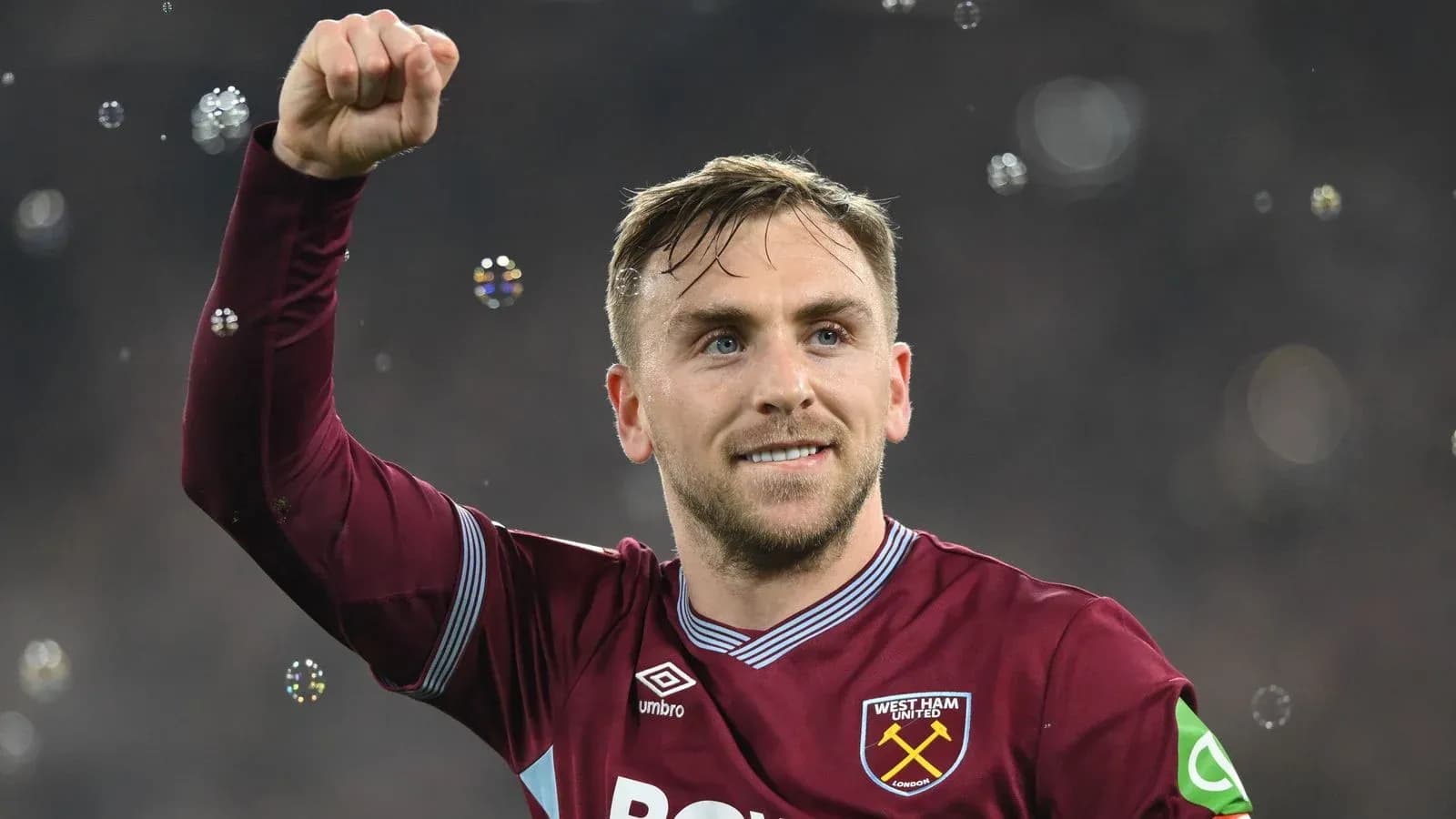 Player celebrating with raised fist in stadium Player celebrating with raised fist in stadium