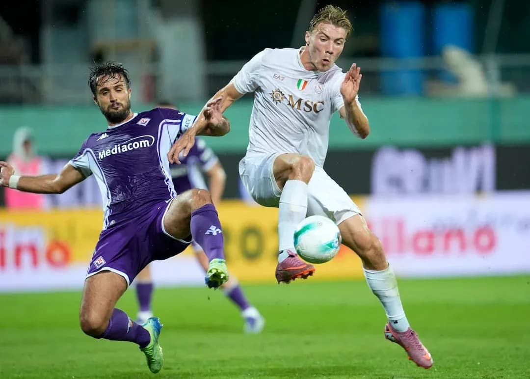 Fiorentina player challenging Napoli opponent for ball Fiorentina player challenging Napoli opponent for ball