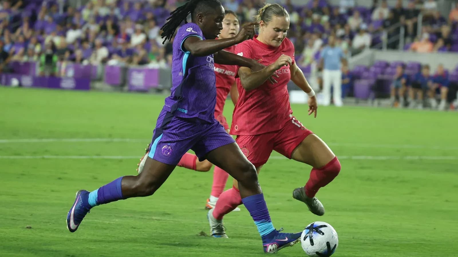 Orlando Pride player dribbling past Boston Legacy defender Orlando Pride player dribbling past Boston Legacy defender