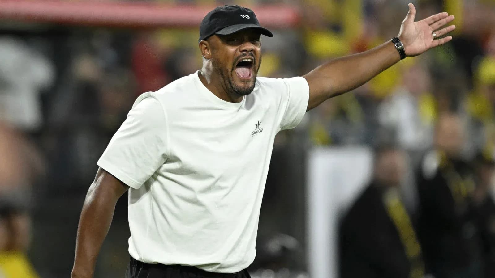 Coach gesturing during a match on the sidelines Coach gesturing during a match on the sidelines