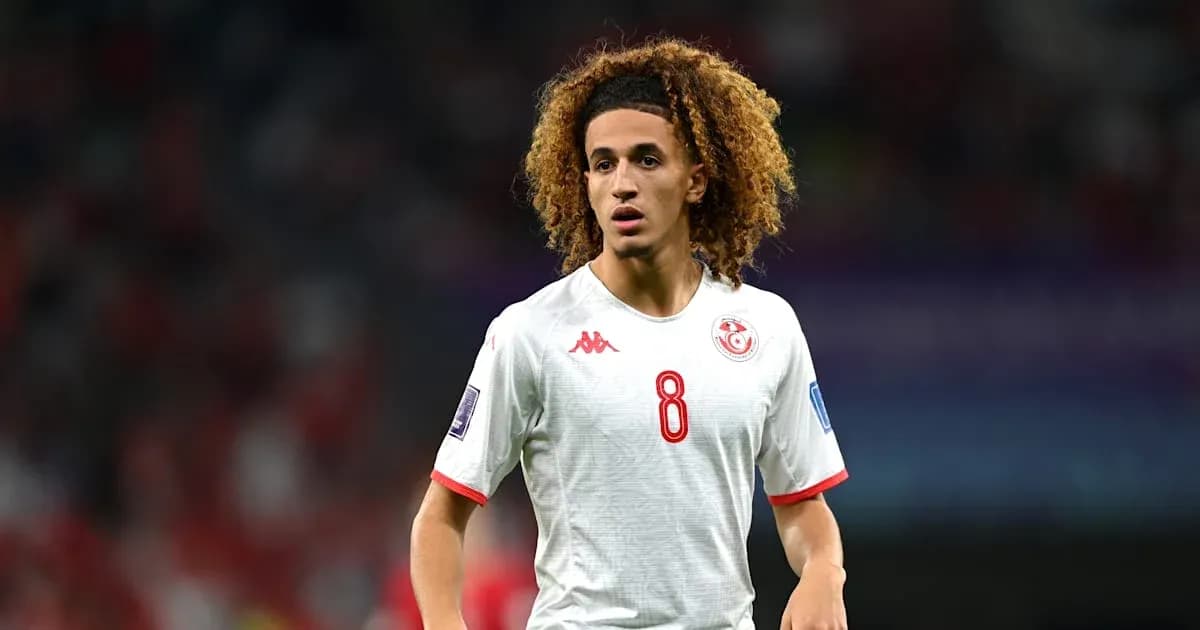 Player in white jersey on football pitch Player in white jersey on football pitch