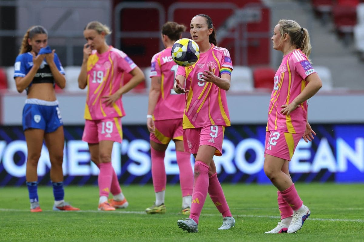 Players in pink jerseys on field during match Players in pink jerseys on field during match