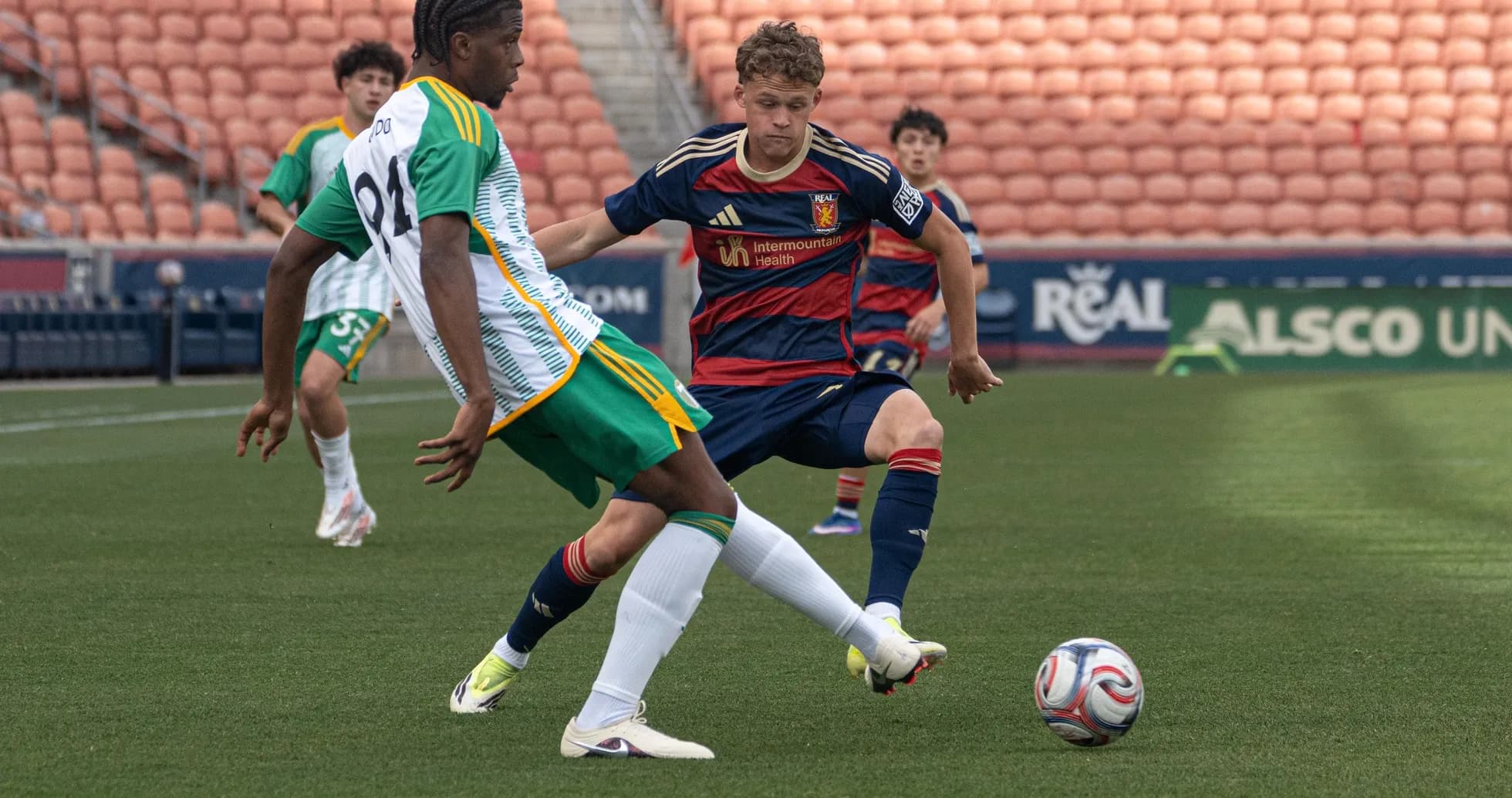 Players competing for the ball in MLS Next Pro match Players competing for the ball in MLS Next Pro match
