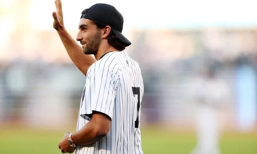 Man waving while wearing a baseball jersey Man waving while wearing a baseball jersey