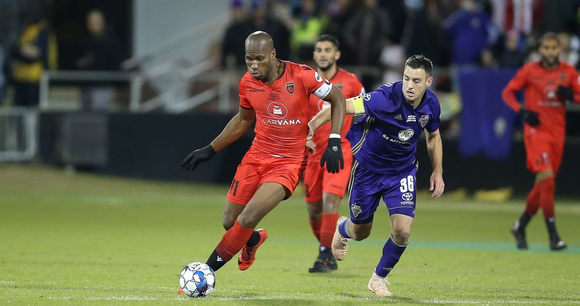 Phoenix Rising player dribbling against Louisville City Phoenix Rising player dribbling against Louisville City