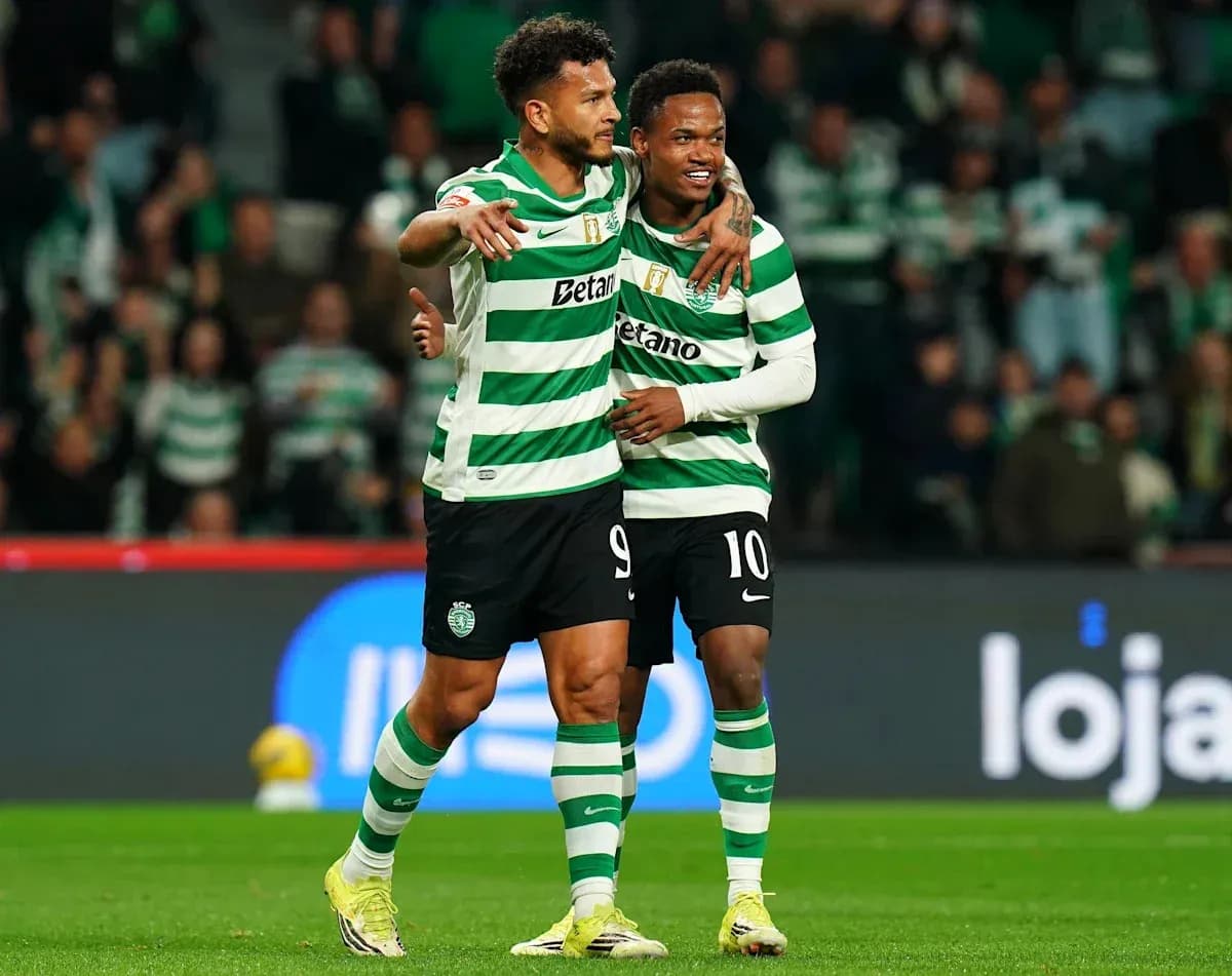 Two players celebrating a goal on the pitch Two players celebrating a goal on the pitch