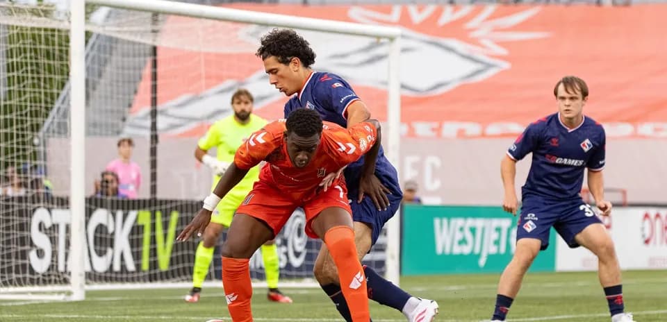 Players competing for the ball in match action Players competing for the ball in match action