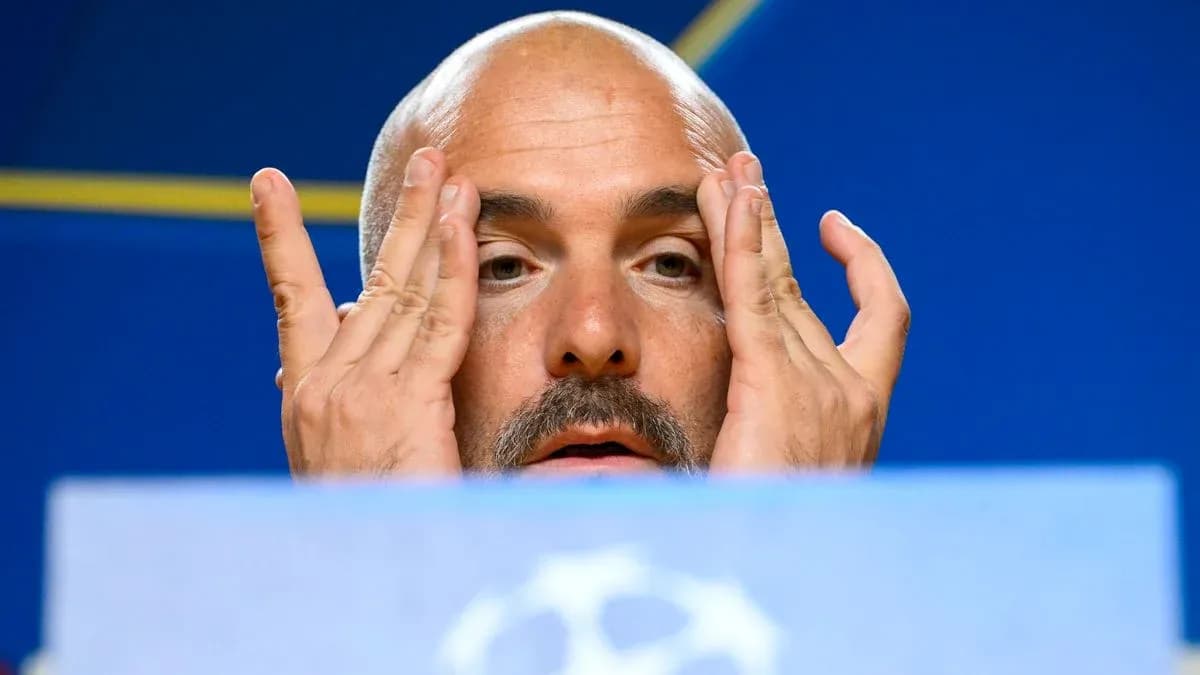 Coach gesturing during a press conference appearance Coach gesturing during a press conference appearance