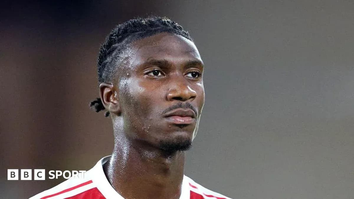 Football player in red and white jersey during match Football player in red and white jersey during match