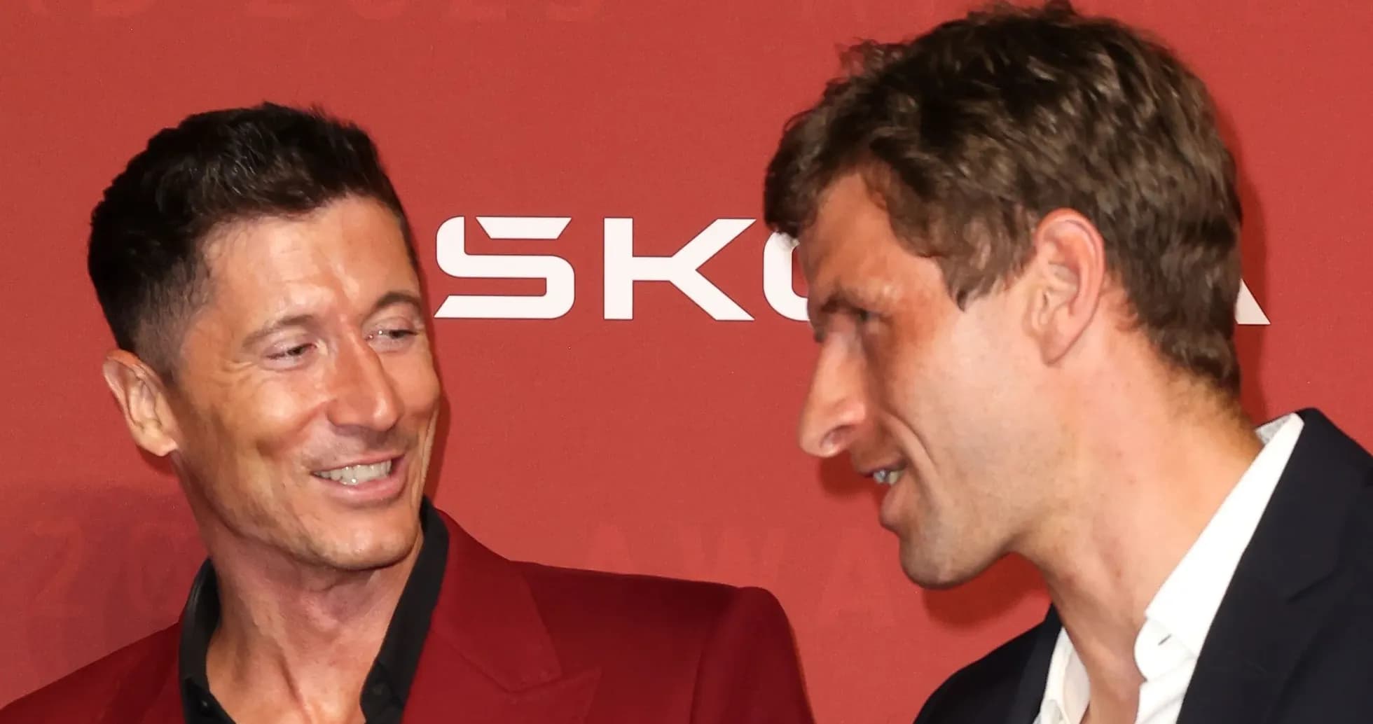 Two football players conversing at an awards event Two football players conversing at an awards event