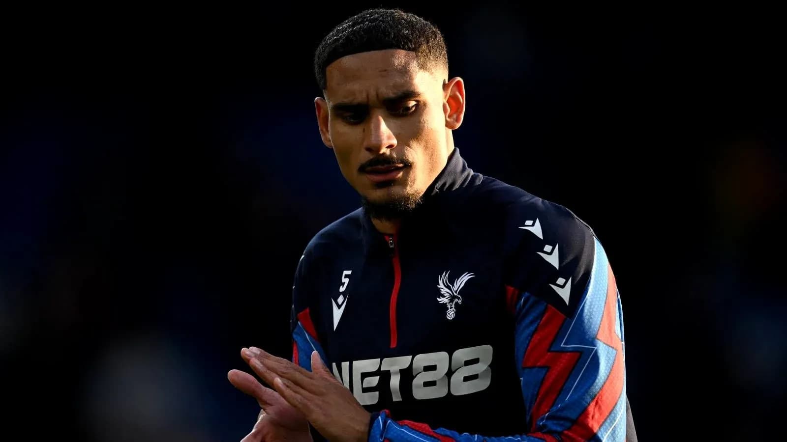 Player in Crystal Palace training kit preparing for match Player in Crystal Palace training kit preparing for match
