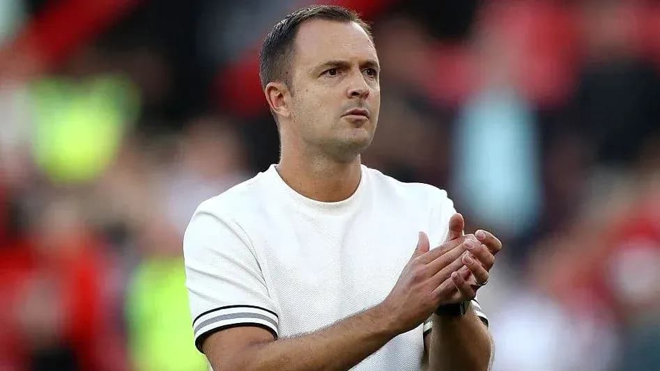 Coach applauding during a match at the stadium Coach applauding during a match at the stadium