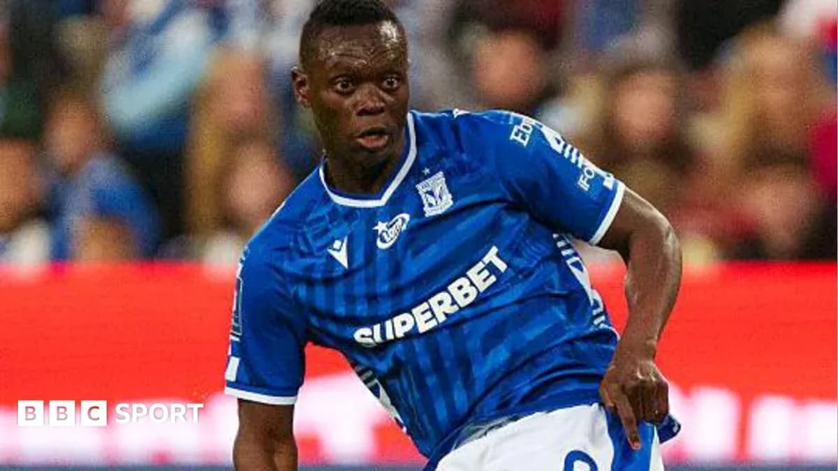Player in blue jersey dribbling the ball during match Player in blue jersey dribbling the ball during match