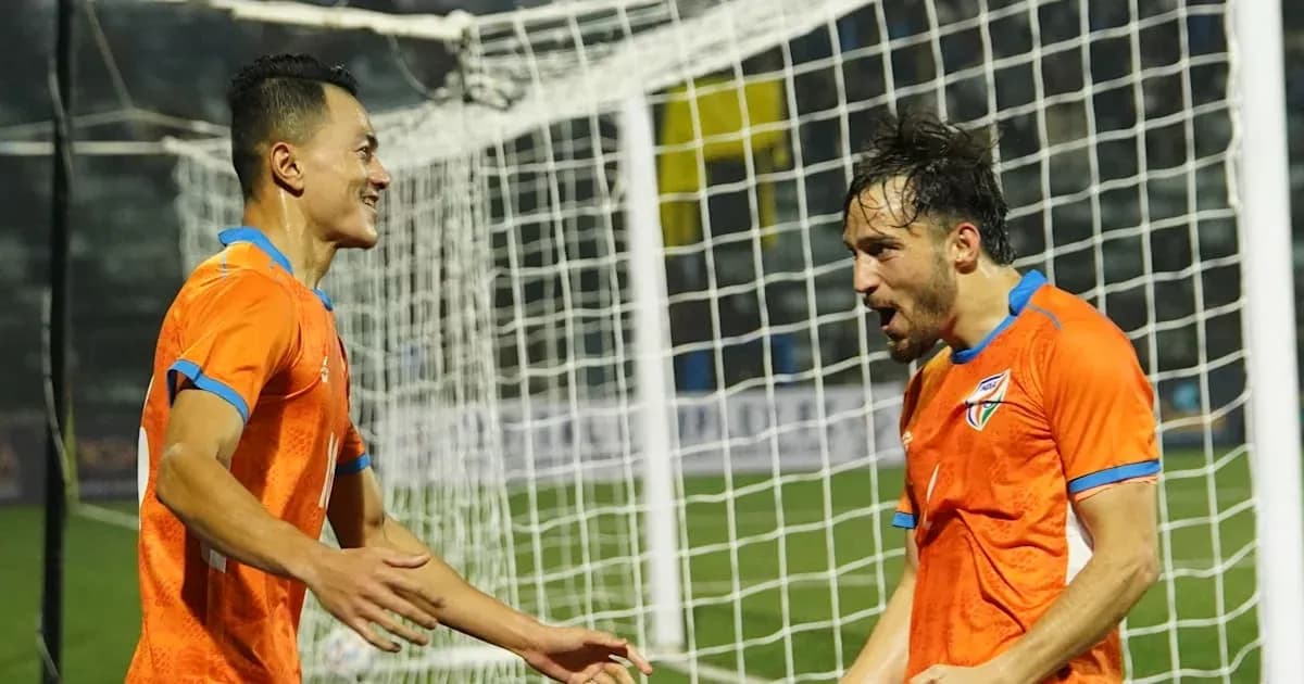 Two players celebrating a goal on the field Two players celebrating a goal on the field