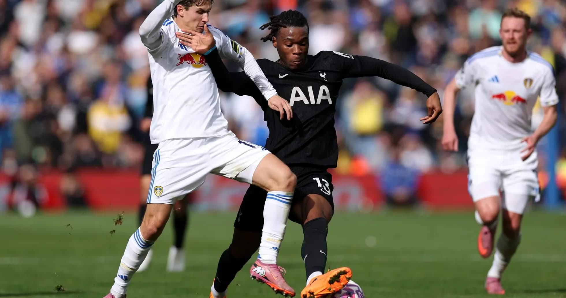 Player from Tottenham tackling Leeds player Player from Tottenham tackling Leeds player