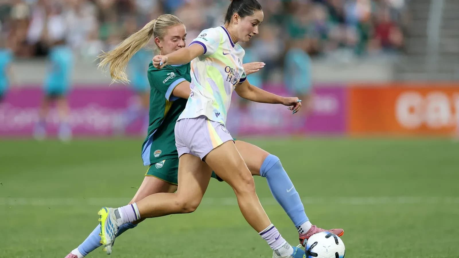 Player tackling opponent during NWSL match Player tackling opponent during NWSL match