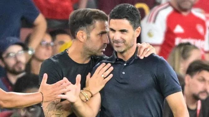 Two coaches talking on the sidelines during a match Two coaches talking on the sidelines during a match