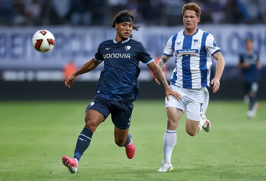 Player dribbling the ball with opponent chasing Player dribbling the ball with opponent chasing