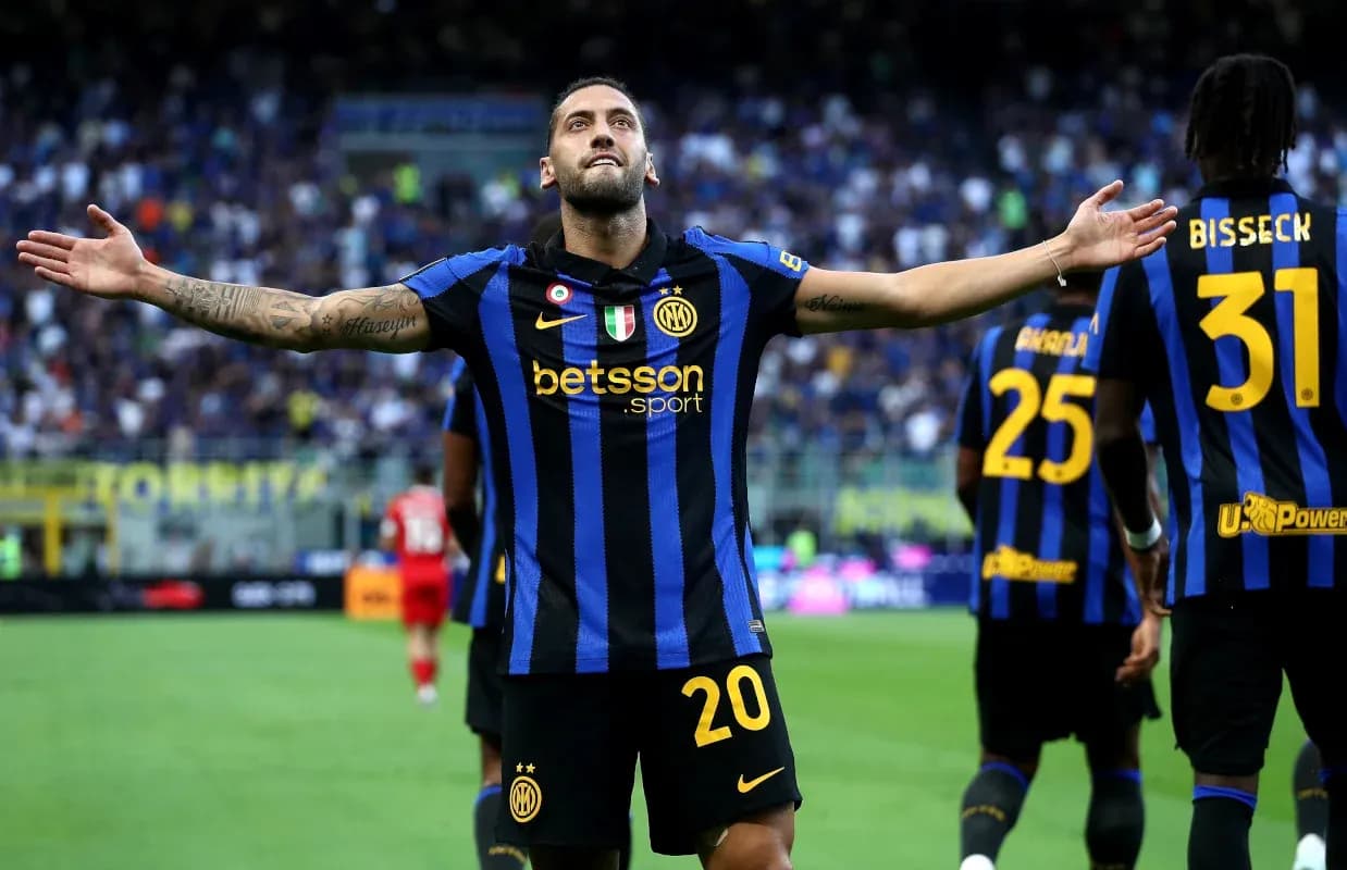 Player celebrating a goal with teammates on pitch Player celebrating a goal with teammates on pitch