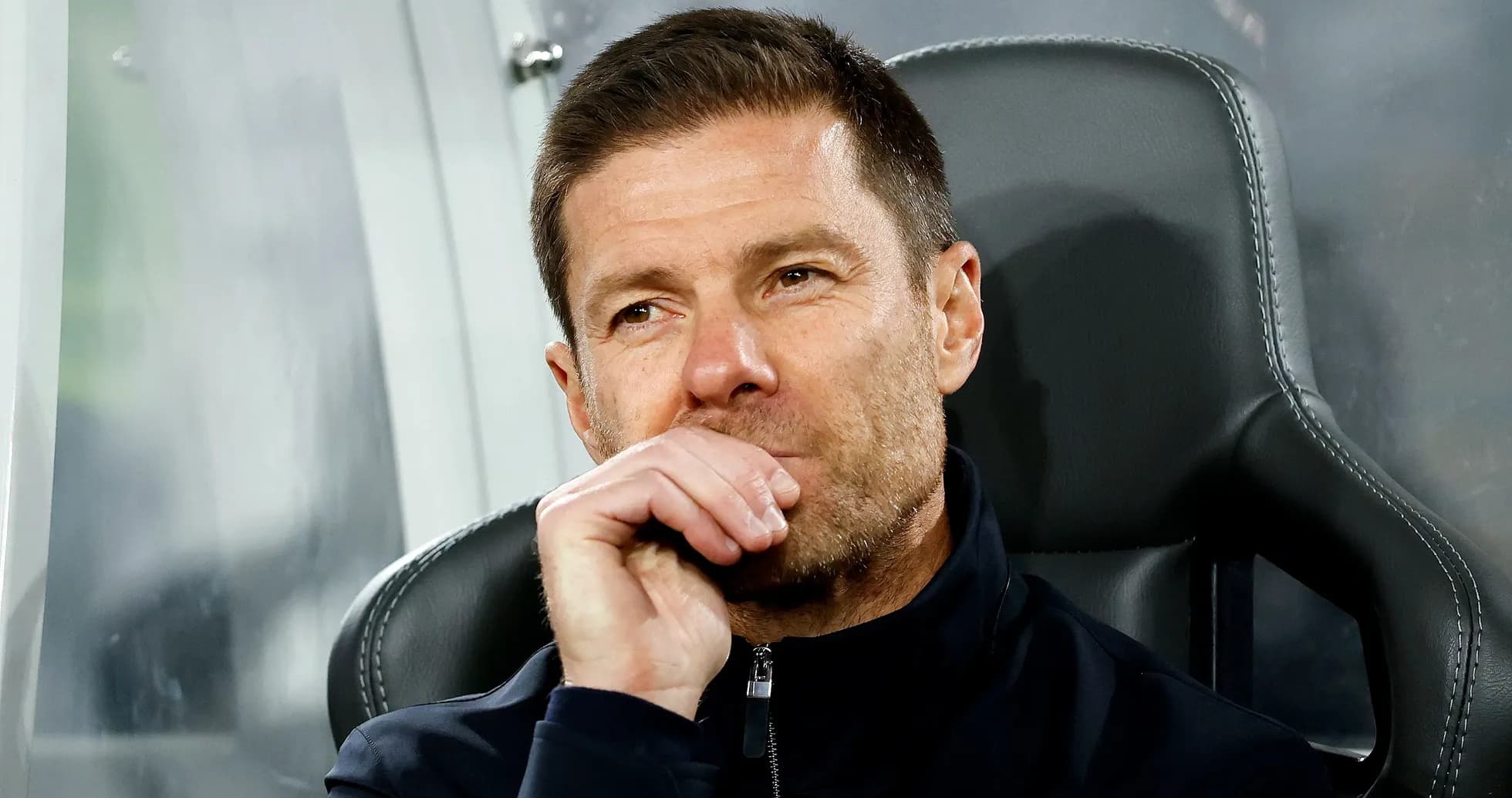 Coach seated on bench during a match Coach seated on bench during a match