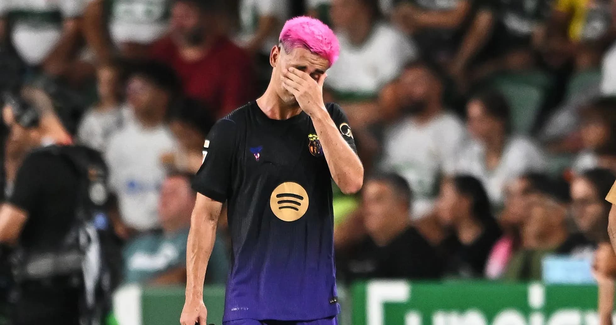 Player with pink hair walking off field, distressed Player with pink hair walking off field, distressed