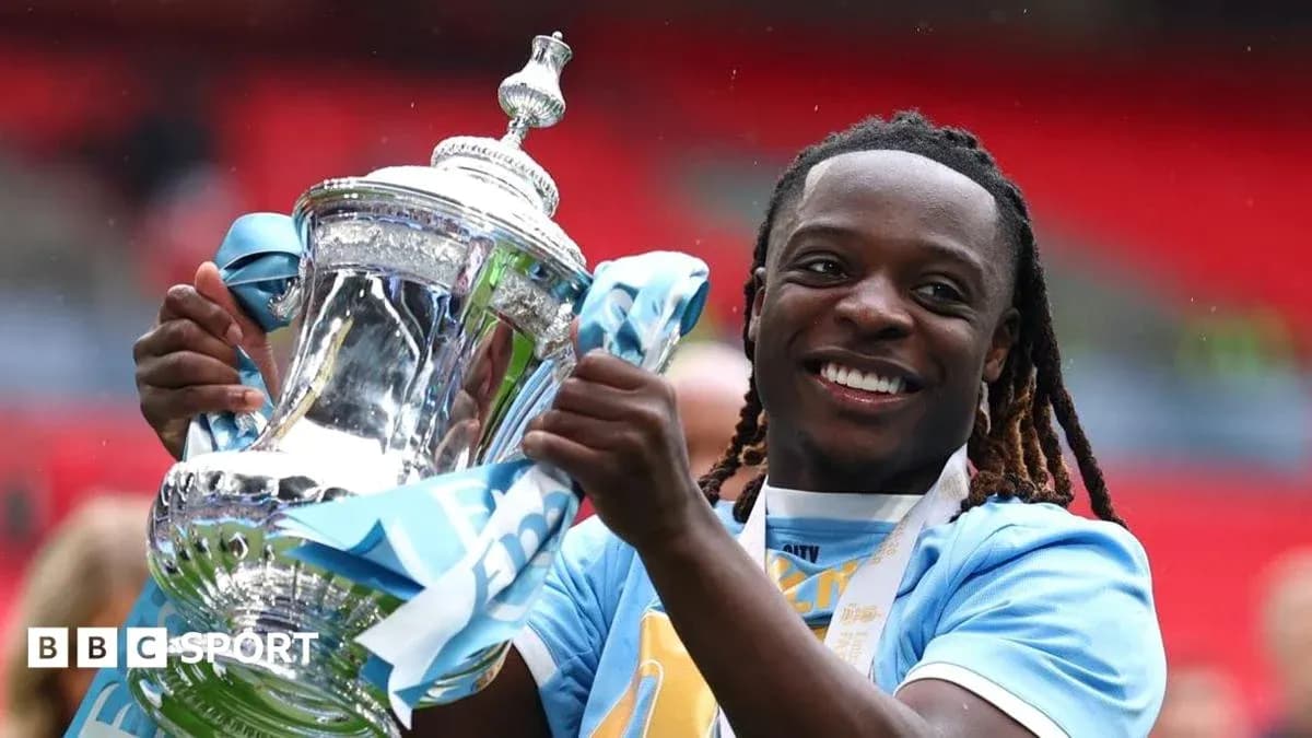 Player celebrating with trophy at Wembley Stadium Player celebrating with trophy at Wembley Stadium