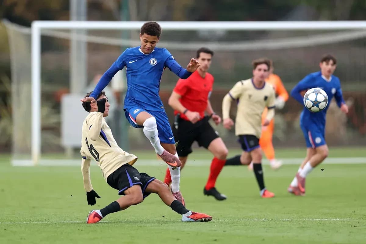 Player in blue jumps over opponent on the field Player in blue jumps over opponent on the field
