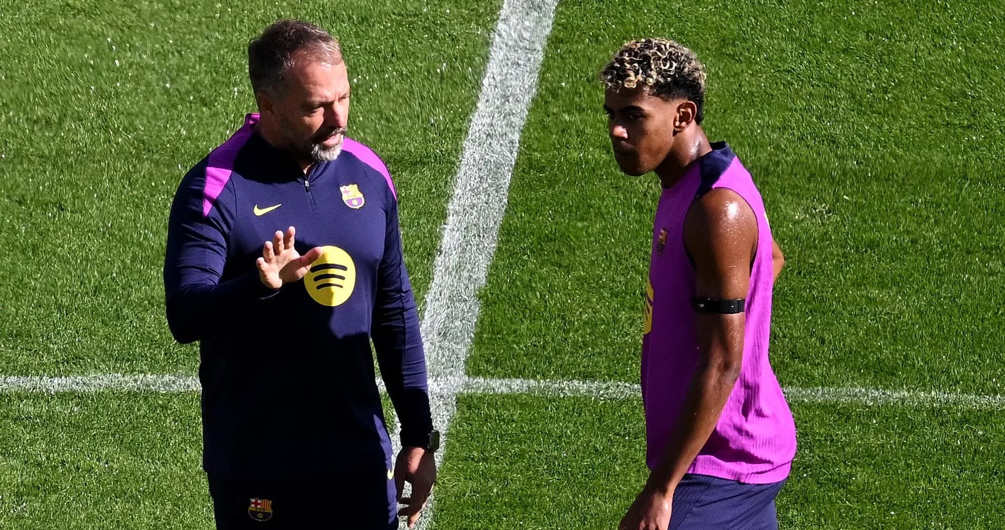 Coach discussing tactics with player during training session Coach discussing tactics with player during training session