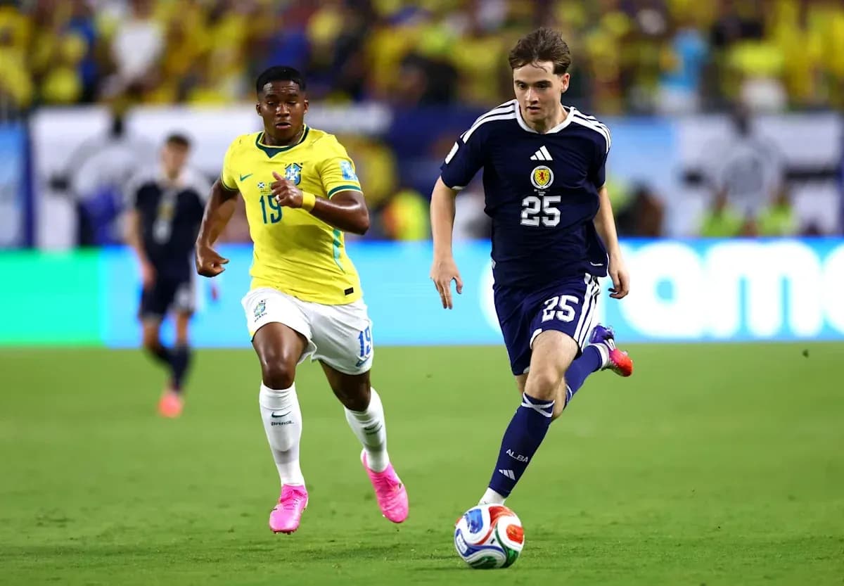 Player from Scotland dribbling past Brazilian opponent Player from Scotland dribbling past Brazilian opponent