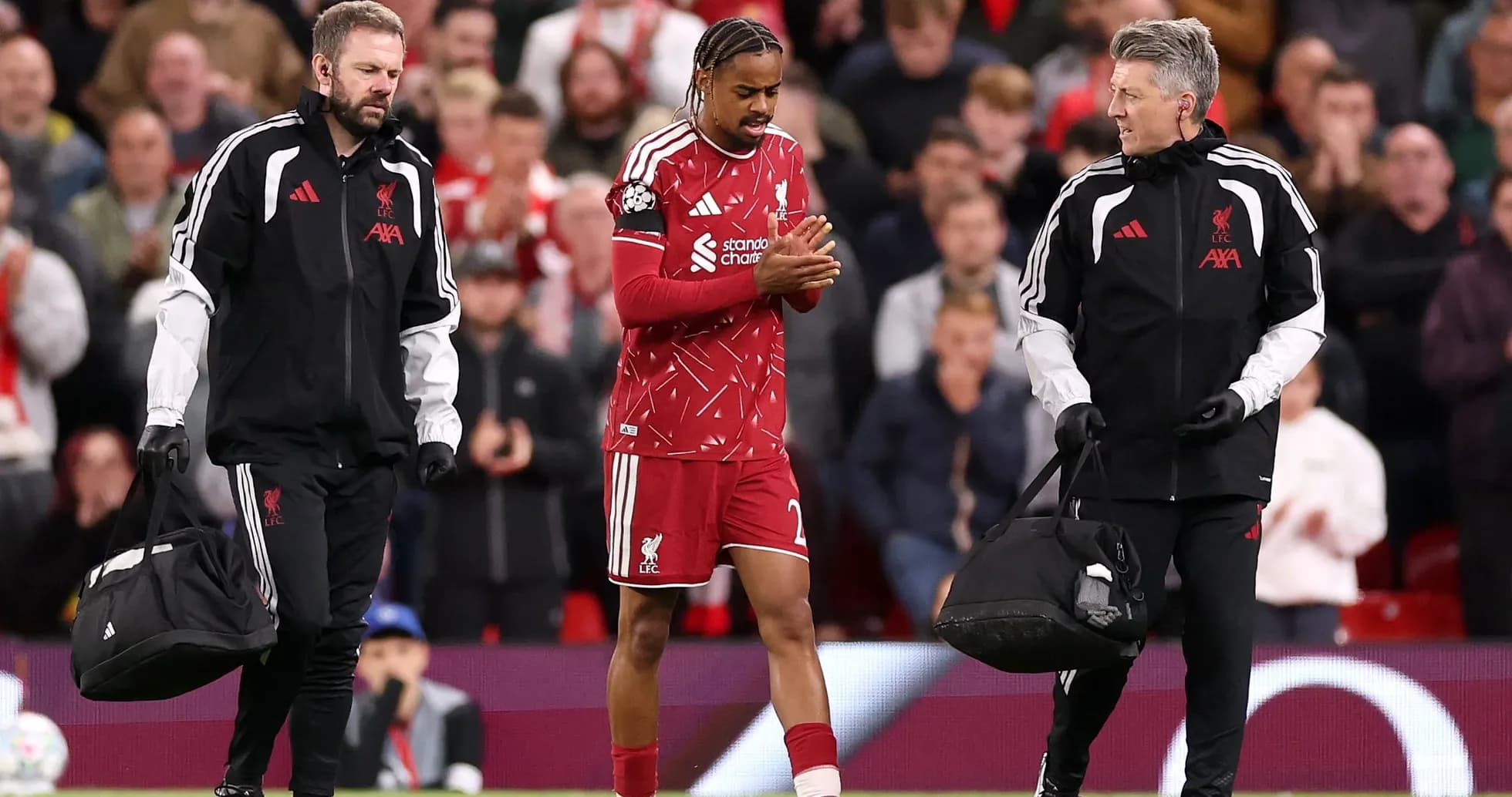 Liverpool player receiving assistance from medical staff Liverpool player receiving assistance from medical staff