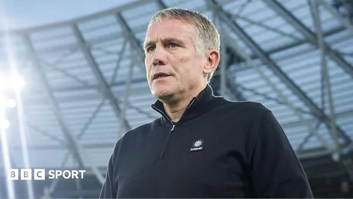 Manager speaking at stadium before match Manager speaking at stadium before match