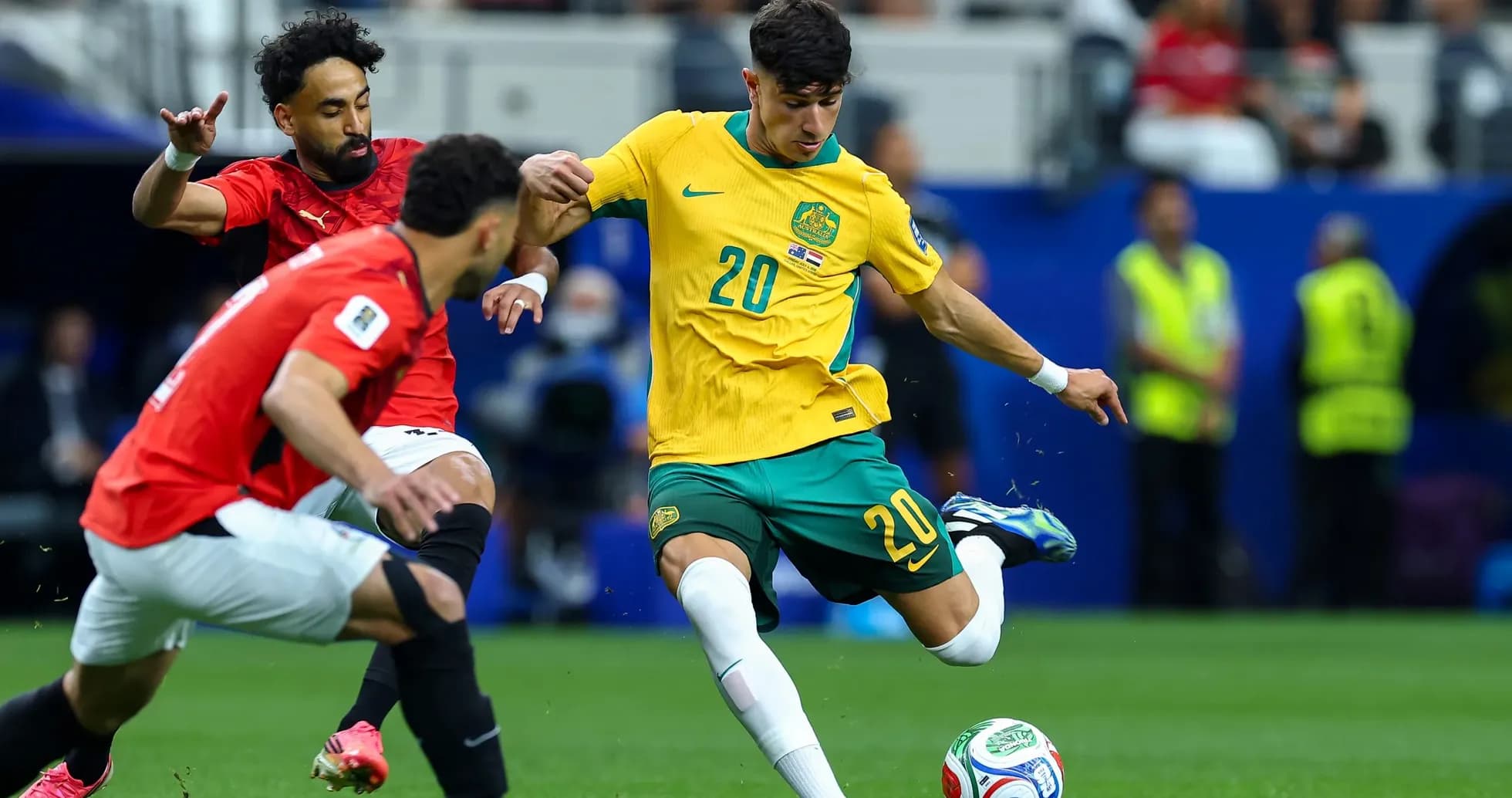 Australia player attempting to dribble past Egypt opponents Australia player attempting to dribble past Egypt opponents