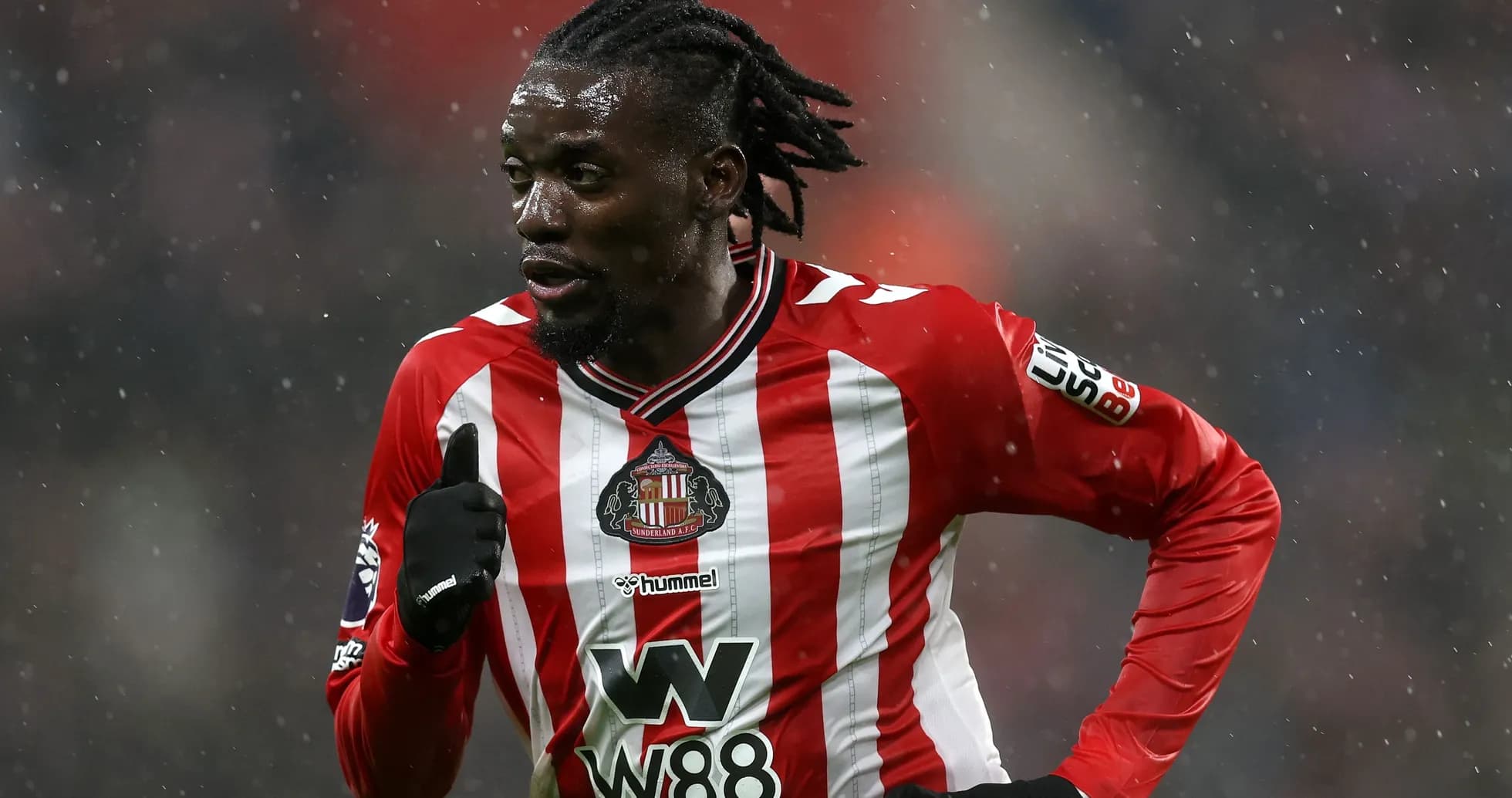 Sunderland player running in the rain during match Sunderland player running in the rain during match