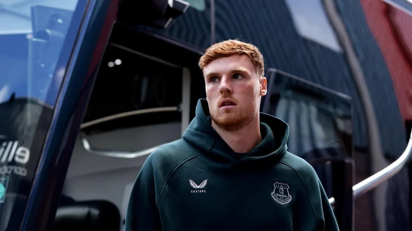 Player in Everton hoodie near team bus Player in Everton hoodie near team bus