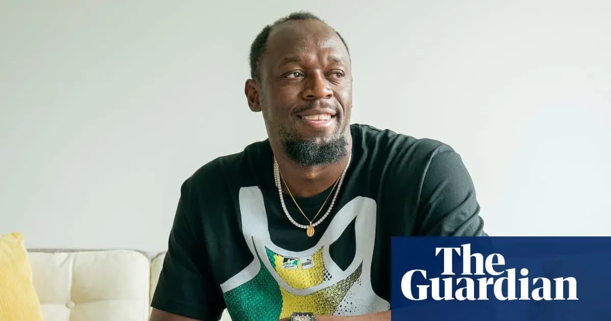 Athlete sitting on couch, smiling at camera Athlete sitting on couch, smiling at camera
