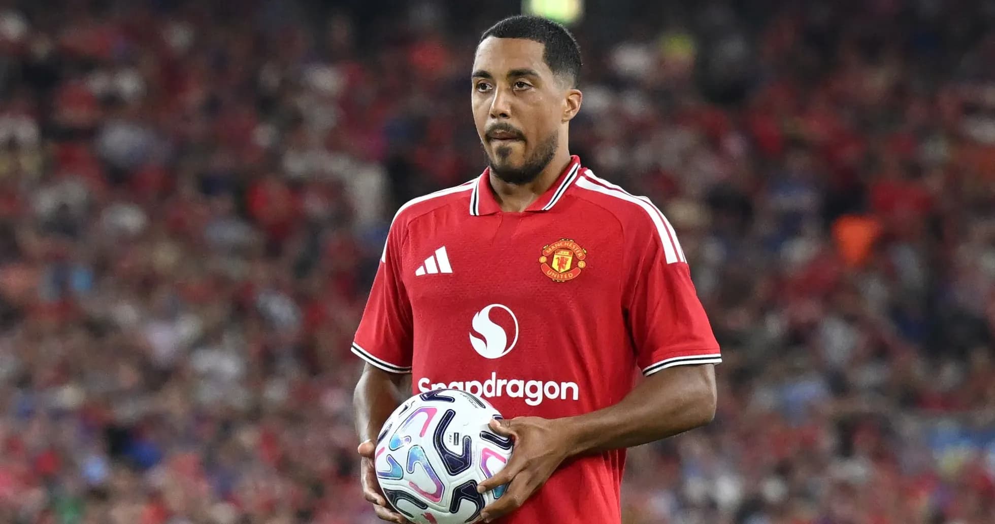 Player in Manchester United kit holding a soccer ball Player in Manchester United kit holding a soccer ball