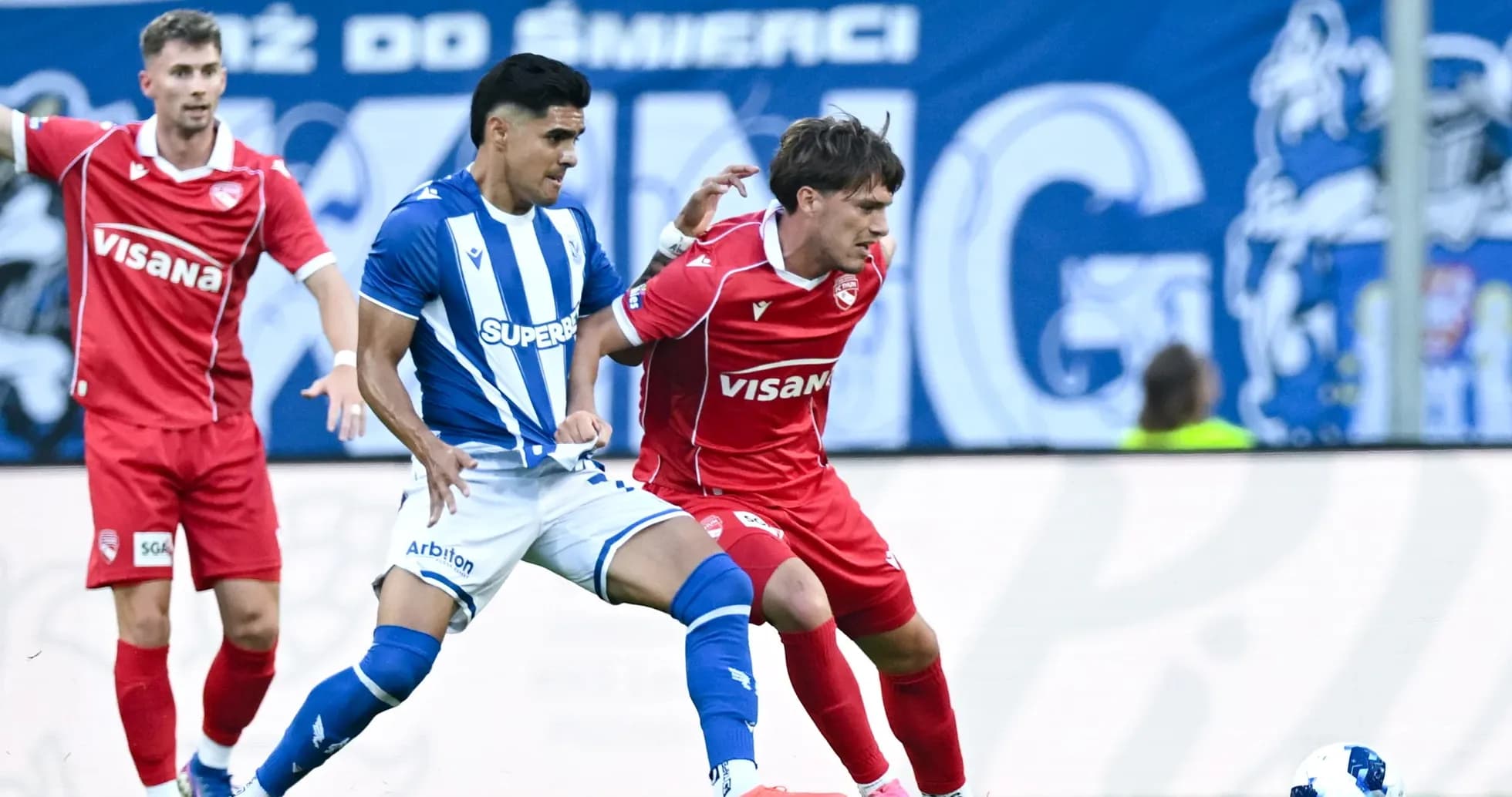 Lech Poznan player tackling FC Thun opponent Lech Poznan player tackling FC Thun opponent