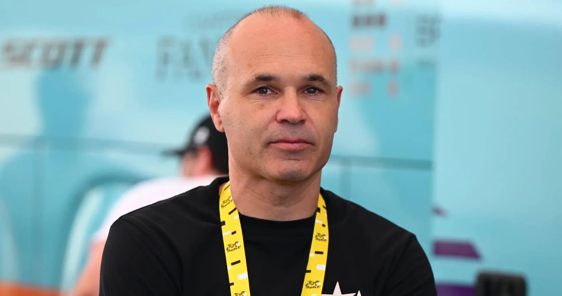 Man with a lanyard at cycling event backdrop Man with a lanyard at cycling event backdrop