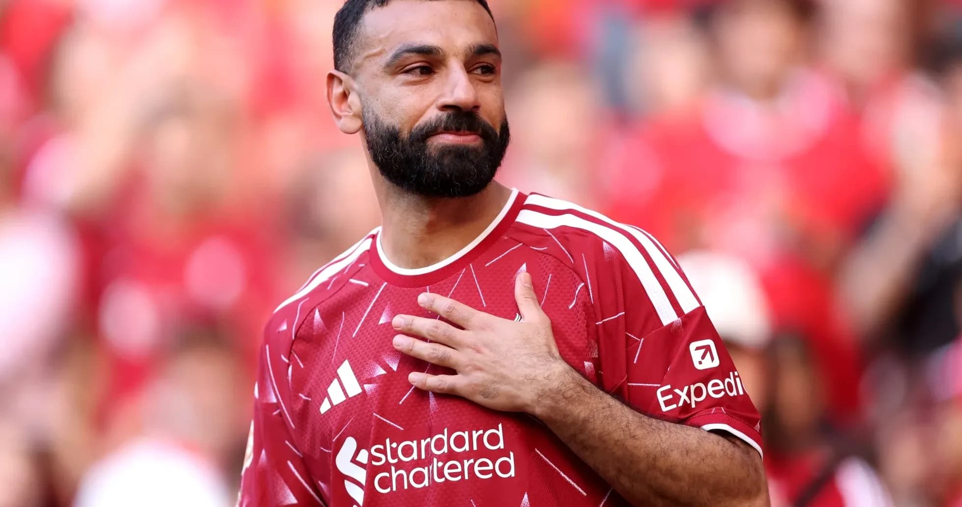 Player in red jersey acknowledging the crowd Player in red jersey acknowledging the crowd