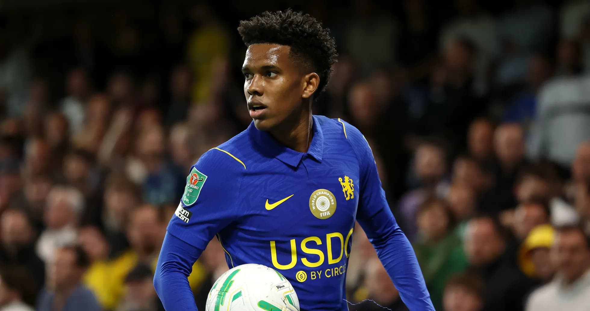 Player in blue jersey holding a soccer ball Player in blue jersey holding a soccer ball