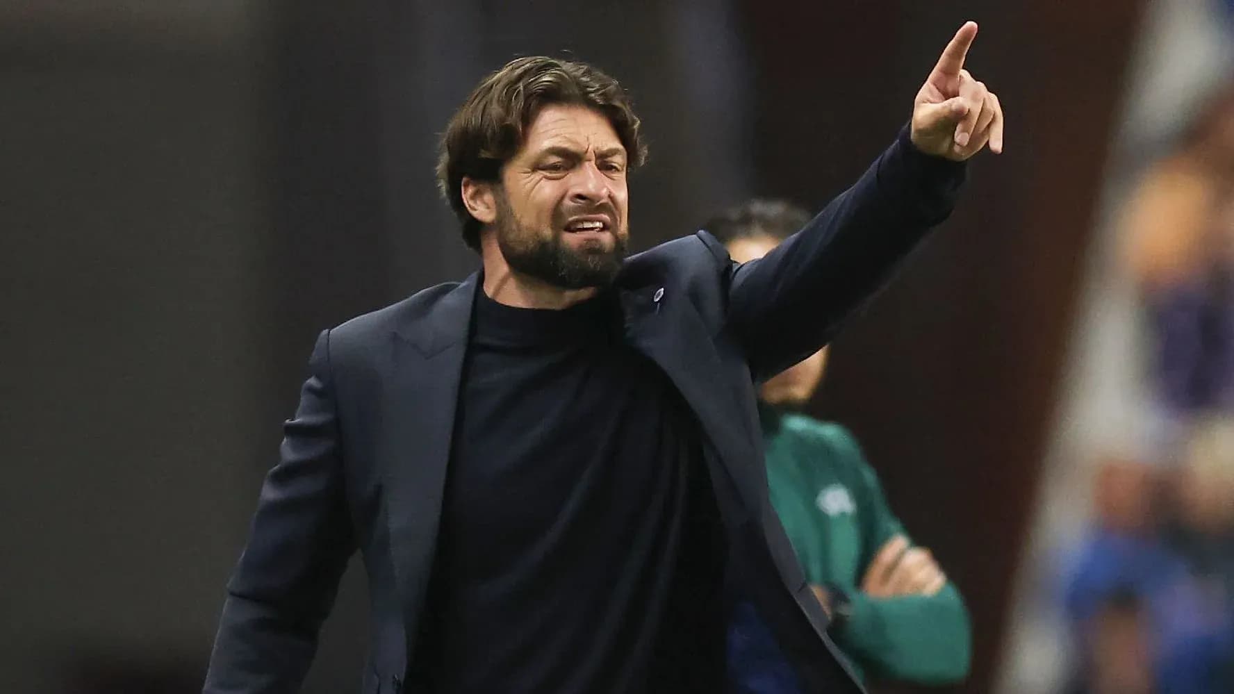 Coach gesturing during a match on the sidelines Coach gesturing during a match on the sidelines