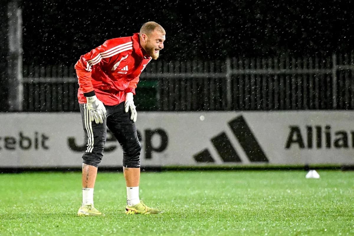 Goalkeeper training in rain at football pitch Goalkeeper training in rain at football pitch